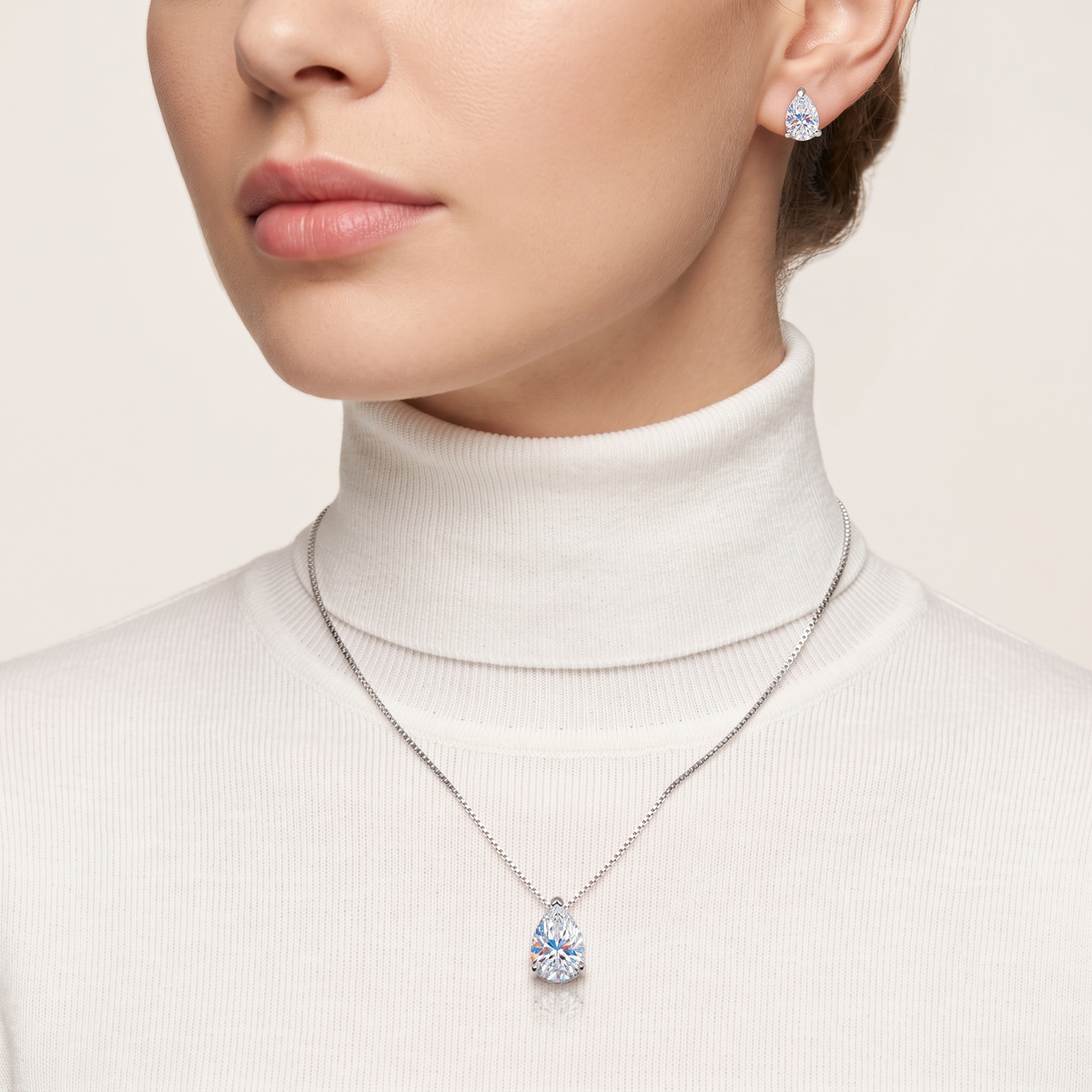 Model wearing sterling silver teardrop necklace and earrings with zircon stones — Golden Rose Arts
