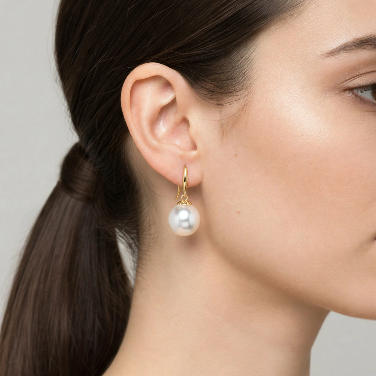 Close-up of model wearing majestic white dangle earrings with white pearl — Golden Rose Arts