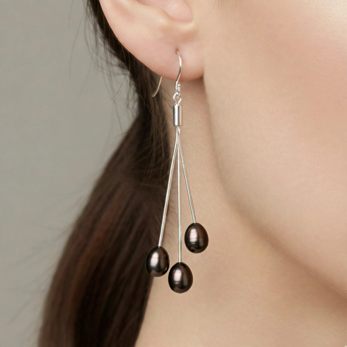 Brown trilogie freshwater pearl drop earring worn on ear, close-up — Golden Rose Arts