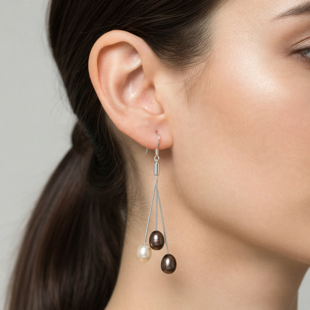 Trilogie earring with two brown and one white pearls worn on ear — Golden Rose Arts