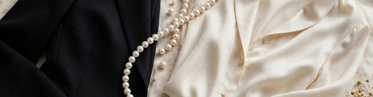 Pearl necklace and earrings styled on a black blazer and ivory blouse