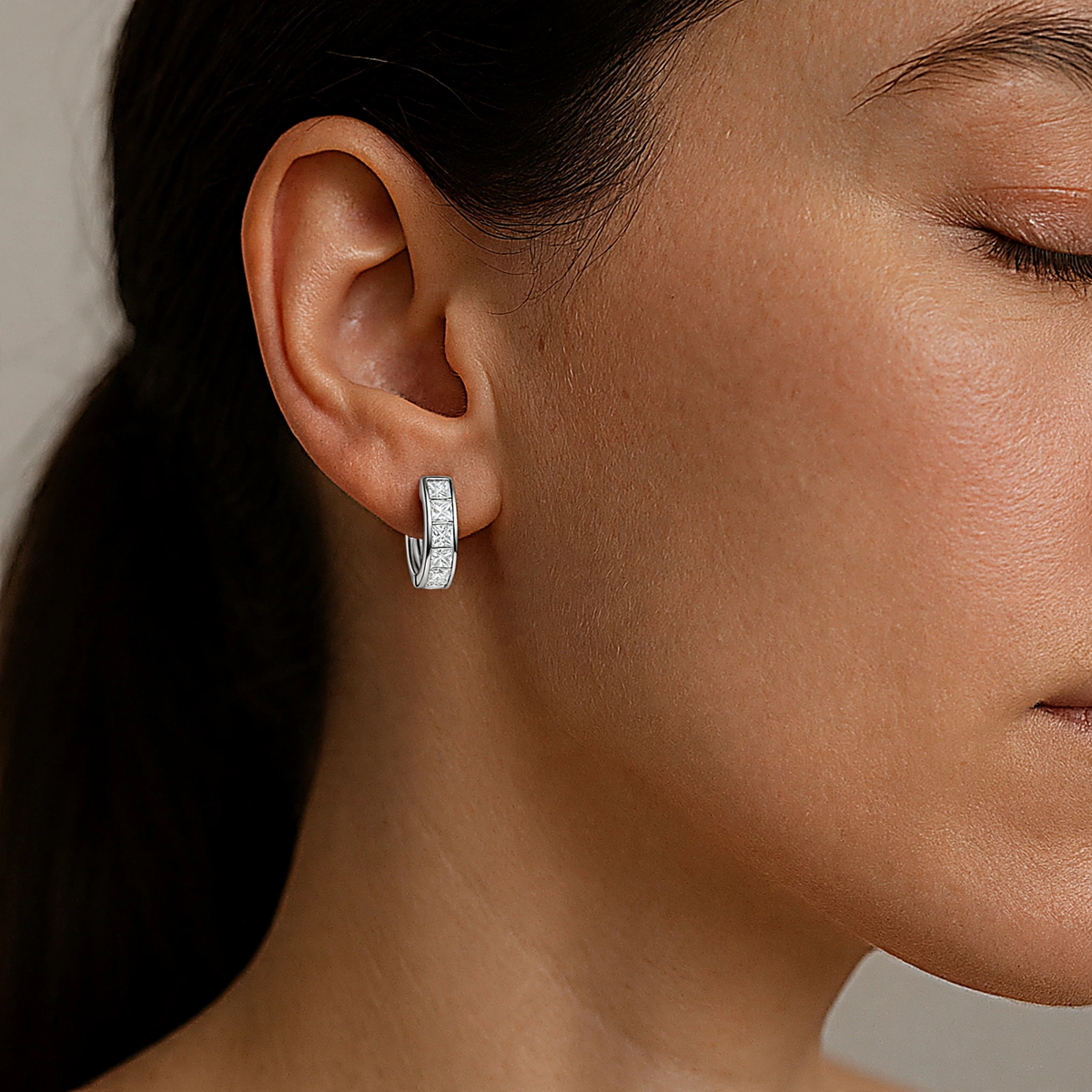 Model wearing sterling silver huggie hoop earrings with zircon stones — Golden Rose Arts