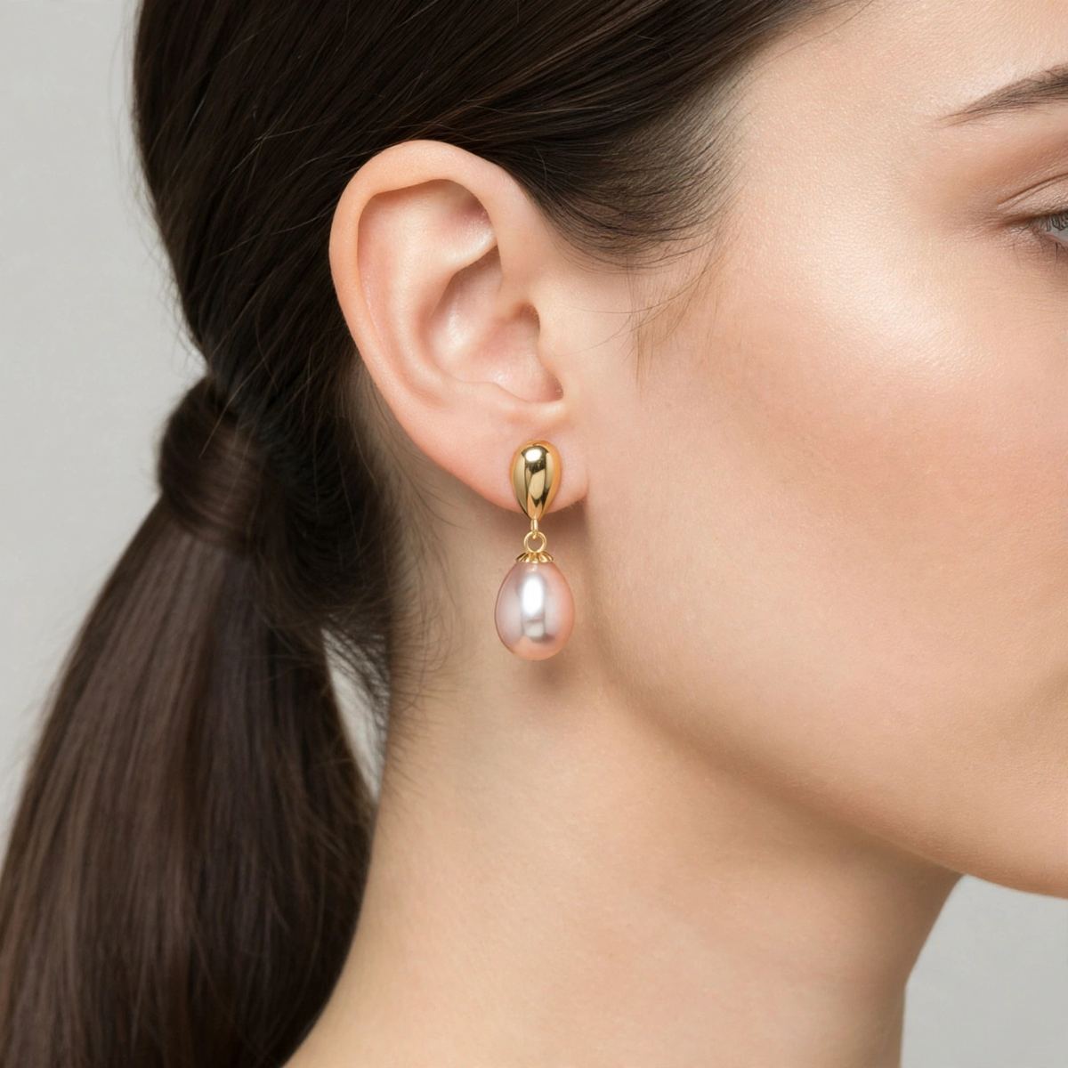 Close-up of model wearing pink serenity dangle earrings with teardrop pink pearl — Golden Rose Arts