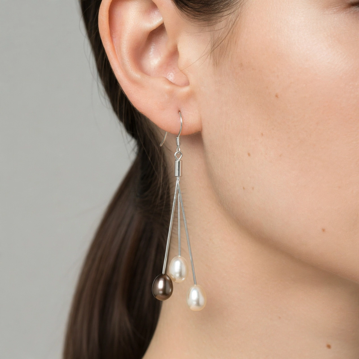 Trilogie earring with two white and one brown pearls worn on ear — Golden Rose Arts